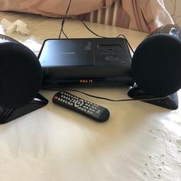 DVD player. Plays music CDs. Old iPod docking station. HDMI port. 2 speakers. Used but in perfect working order. Remote. Couple of scratches on it. Great for kids.