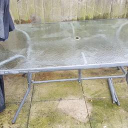 Garden table 6 chairs and parasol. Needs tlc as been left out all winter. Offers?.