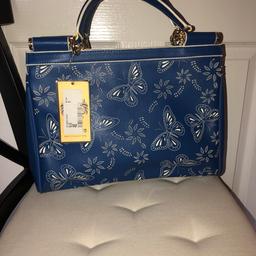 A brand new blue handbag with butterfly pattern suitable for summer