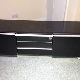 Tv unit/ cabinet for sale
In excellent condition. Selling as we are moving into a furnished flat. 
Black glossy finish which compliments your living room and goes well with any furniture
Has 3 slots for DVD/blu ray player, PlayStation/ Xbox and other stuff. Top drawer a bit temperamental but nothing serious.
2 Huge and deep drawers to hold your cds/dvds games consoles wires etc. 
Open slot at the rear for convenience. 
Collection only 
Grab a bargain at the price stated.
Needs to be picked today