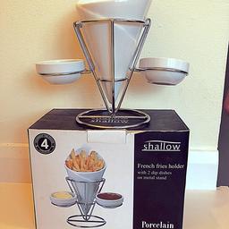 Set of two porcelain French fry holders, still in box. Comes with stand and two dipping pots.

Used once, lovely server wear. Excellent condition.