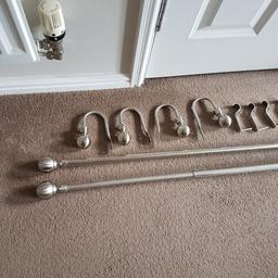 2 brushed steel curtain poles , with fittings , apart from one pole end which is missing.plus matching curtain hold backs