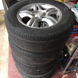 4 wheels with tyres fit Kia Sportage around 2007, tyres not up to much see photos.