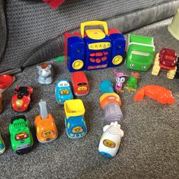 Random bundle of toys which includes CD player, cars, musical paint brush, and 10 toot toot vehicles.
