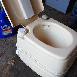 Compact toilet suitable for camping or caravan. Has a brush in the lid. Free bottle of Elsan loo bloo with it.