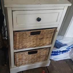 Small side table including 3 drawers, 2 of which are large wicker ones which can hold quite alot.

Around 60cm tall and 40cm wide, some marks on top but could be painted if you so wished.