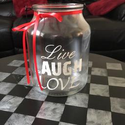 Very large glass jars with wire handle and 
‘Live, Laugh, Love’ on the front , wine bottle and lights are to show how big they are only and are not  included!! Used these for flowers and candles for our wedding and have 4 for sale at £10 each. I’ve kept some and put lights in and another has all the corks from the champagne from the toasts.