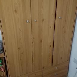 A 3 door wardrobe with a rail, 4 shelves, a long shelf above rail and 4 drawers. Please note as its quite old there maybe some nicks and scuffs, and the bottom left hand drawer is missing, It just has the drawer front. Dimensions H - 180cm, D - 50cm and W - 110cm. Will be disassembled.