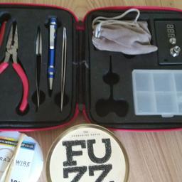 Coil Master kit (scissors missing), but includes wire and Fuzz cotton.