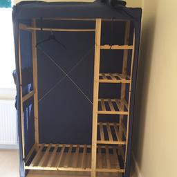 Dark blue heavy duty cotton, over wood framed wardrobe. 5 shelves, external pockets, perfect condition, surplus to requirements.