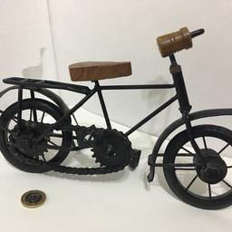 Metal body and wooden handle and seat , classic bicycle model for display, hand crafted with working saddle moving the back wheel through chain, front wheels turns right and left, rotating wheels. Excellent show piece.
