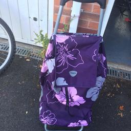Purple and pink shopping trolley approx  1 metre in height to top of handle , zip pocket on back and drawstring on main front section. Good condition, collection from Warwick gates