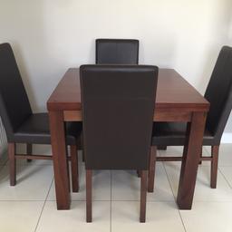 Beautiful solid mango wood dining table and 4 faux leather chairs. Bought from Next. This is very heavy being solid mango wood, will require a couple of people to lift. Selling for a friend due to house move. 

Cost over £500 new, no offers