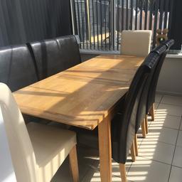 Solid oak table with 6 brown chairs & 2 cream. The table is extendable. One of the cream chairs is marked and the other has some marks on. £120