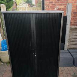 a large steel locker cupboard with sliding doors, ideal for tool storage or camping stuff, garden equipment etc,  measures 60in tall, 39in wide, heavy so pickup only 18in deep.