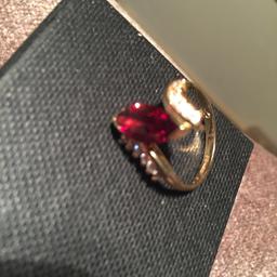 Beautiful 9ct Marquis Garnet Ring, with cubic zirconia's each side of the clear garnet. Weighs 3.9 grams size N. Has been worn before the ring is in excellent condition, selling cheap.