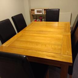 Solid oak table and 5 leather black chairs,
Extend from the middle from 59 to 82 inches
Very heavy will need two men to carry,
Cost over £700 new