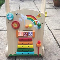 Includes abacus, xylophone, clock and turning wheels. Room at the back to put toys.