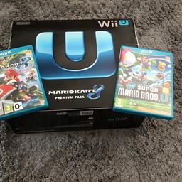 Wii U boxed in good used condition with 2 x games. All accessories and instructions included.