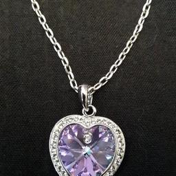 This stunning necklace comes with swaovski crystals around the outside of the heart and a beautiful purple gem.
Very good condition.
Long chain which makes the necklace fit at a comfortable length.
Once the sun hits it, the whole necklace sparkles!