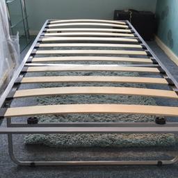 Silver metal framed 3ft single bed with mattress with pull out bed underneath that stands on folding legs (no mattress). Excellent condition.
