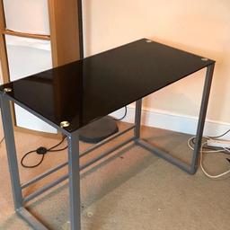 Excellent condition black glass desk. Hardly used. Measurements are:
height- 75cm 
width- 100cm
depth- 50cm
Has been dismantled. One screw was missing from flat pack when purchased but does not affect use. Collection only. Read less