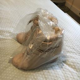Cream/nude coloured wedge trainers brand new from Aldo. 

Never worn, size 5 UK, 3.5 inch wedge. They zip/unzip - no need to undo laces/buckles. 

No box but still in original plastic and immaculate. Was 110 to buy, will take 40. Can post for basic postage cost.