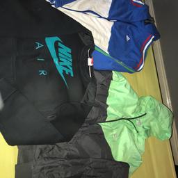 Ex con , small tear green/grey Nike jacket on right lower arm