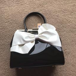 Hi I am selling a brand new “Peaches Accessories” handbag in black patent with bow detail to the front. RRP is £50 as shown on the label. Lovely bag just never used it so someone else may as well get use of it. Willing to post for additional cost. Please ask for further pictures or information.