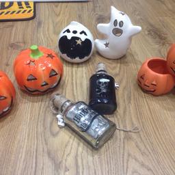 Sold alltogether or in sets 
3 clay pumkins (has some left over wax inside) £1 
White pot candle holders £2
Orange candle holders £2 
Poison bottles £2 
All of them for £5