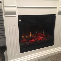 White fire surround with built in electric fire. Full working condition. Surface marks on top shown in picture therefore cheap price. Can deliver for £5. Height 100cm depth 38.5cm width 100 cm