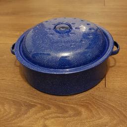 As new blue enamel roasting tin. Width 30cm including handles. 13cm high with lid on.