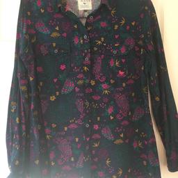 This shirt has peacocks and flowers on a navy back-ground..it is made with a heavy cotton material just right for the winter months and is a size 16....it is made by Country Rose and there is also a jumper that goes with it for sale..check my other items...worn once