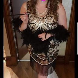Dress, Boa, headpiece, pearls and long black gloves. 

no cigarette holder.

bought for a Hen, will not wear again.