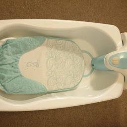 blue and white baby bath with baby support and shower / jacuzzi functions.