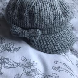Knitted woollen hat with a bow on the side. Never been worn. 