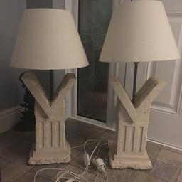 Two solid stone table lamps with shades. 
Approx 75 cm tall
