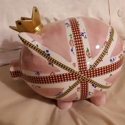 porcelain pink pig money box.  can open at the bottom to get the money out.