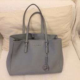 I am selling my beautiful micheal kors tote bag grey/light blue just because I got a new one! There are few make up stains inside and outside but still lot of life left in it! Paid 240 pound for it... open to offers...