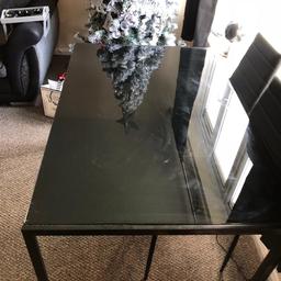 Glass black table for sale, slight scratches on the top of the glass when we brought it, barely a week old. Comes with 2 chairs. £50. Collection only