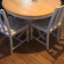 Beautiful solid piece of furniture. All four chairs have beautiful duckegg blue bird print. Table is white base with wooden top. Collection only.