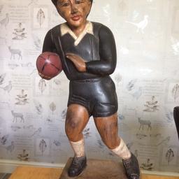 Hand carved figure of a Rugby player in solid hardwood, hand painted. Can be used as an ornament or doorstop. Approximately 20” high and 8” wide including plinth.