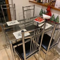Glass table and 4 chairs in good condition.
