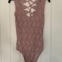 Gorgeous top shop body suit in light pink, ties up at the back. Only worn twice. Comes from a pet and smoke free home.