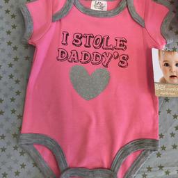 Pink body top with poppers to the bottom
Beautiful design in pink with grey piping round arms and legs
Grey glitter heart on front with wording
“I stole Daddy’s”