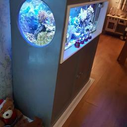 We are selling our marine tank, full set up including all corals (Kenya trees, 2 large nems (not shown in photos) and a large mushroom something?? 🤷‍♀️) lots of live rock plus the 2 clown fish (nemos) and a few small star fish. It's 3ft wide by approx 14 inches deep. The unit stands almost 4ft tall. It's got gorgeous circular 'peep hole' windows either side which adds to the beauty of this tank. It filters using a sump system, which is very easy to use.