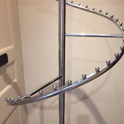 Clothing display stand. Curved waterfall shape in silver and black   Will extend from approx 4ft to 6 ft. 
Tripod stand with fitted castors 
Excellent condition