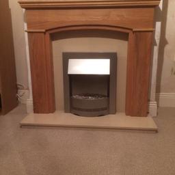 Solid wood fireplace with marble inserts and hearth with electric blower fire