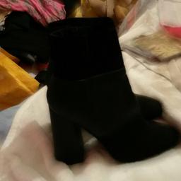 Black size 7 heel boots never been worn like bran new still has stickers on the bottom of boot
