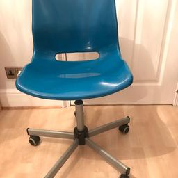 Comfy desk chair in fashionable blue. Stylish addition to a room. Adjustable height.